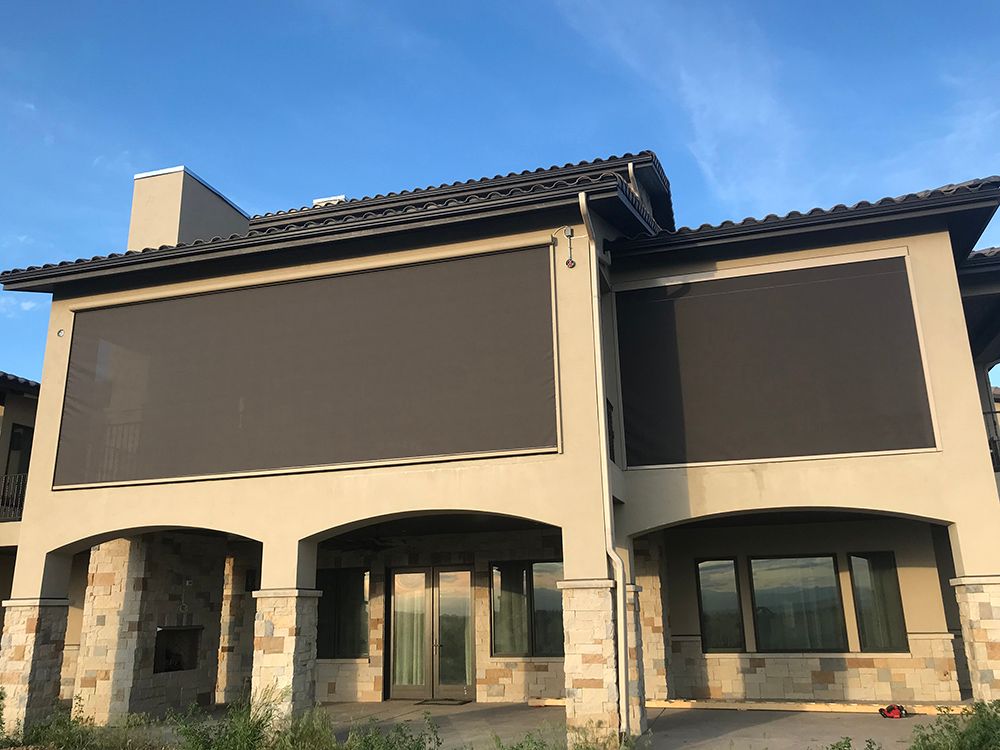 a large house with a lot of windows and a large shade