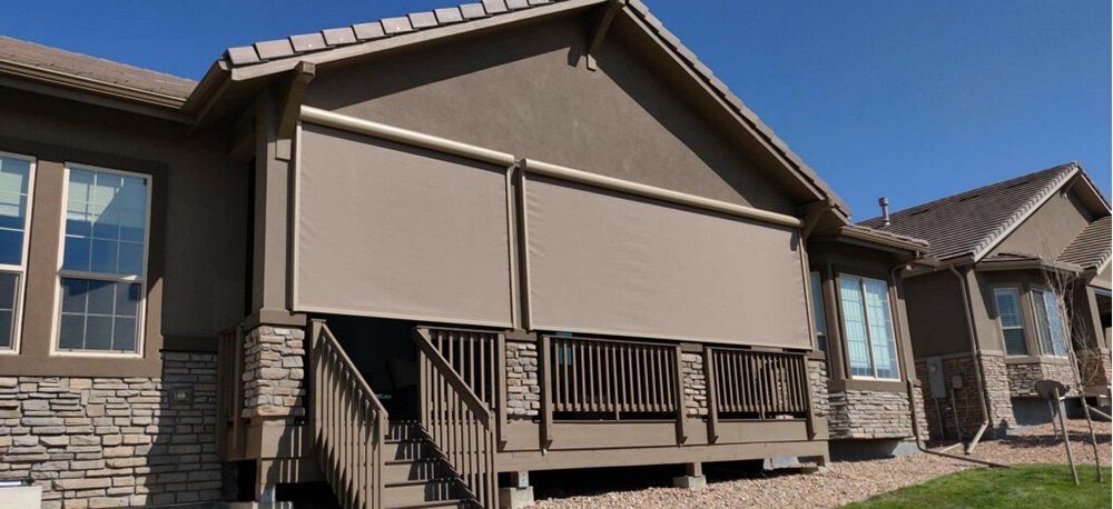 a house with a shade in porch and stairs