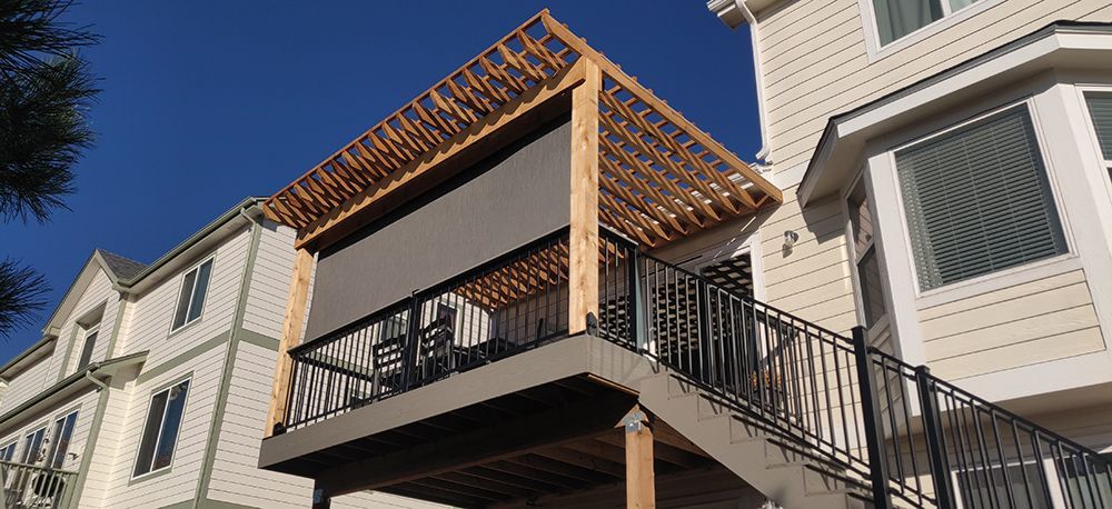 a house with a balcony and stairs on the side of it