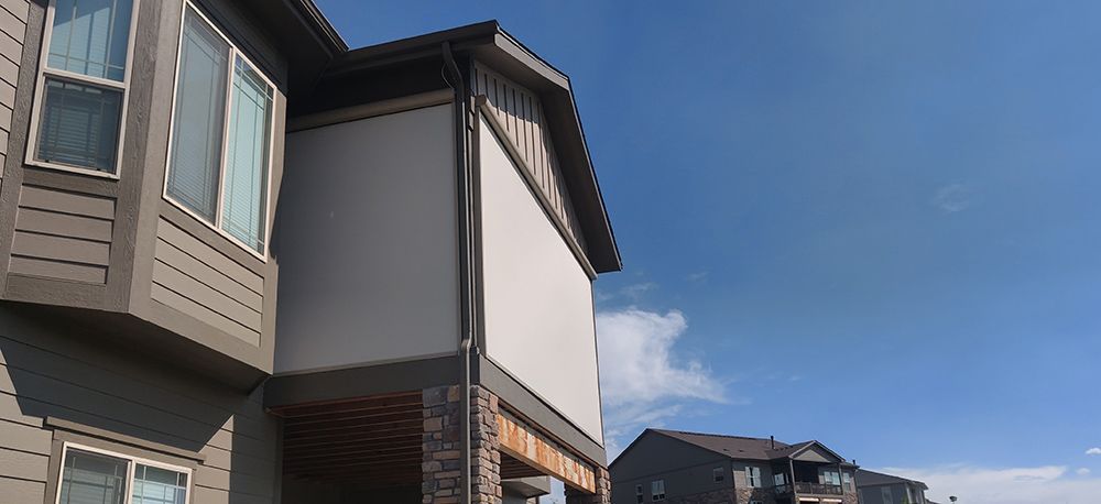a house with a lot of windows and a blue sky in the background