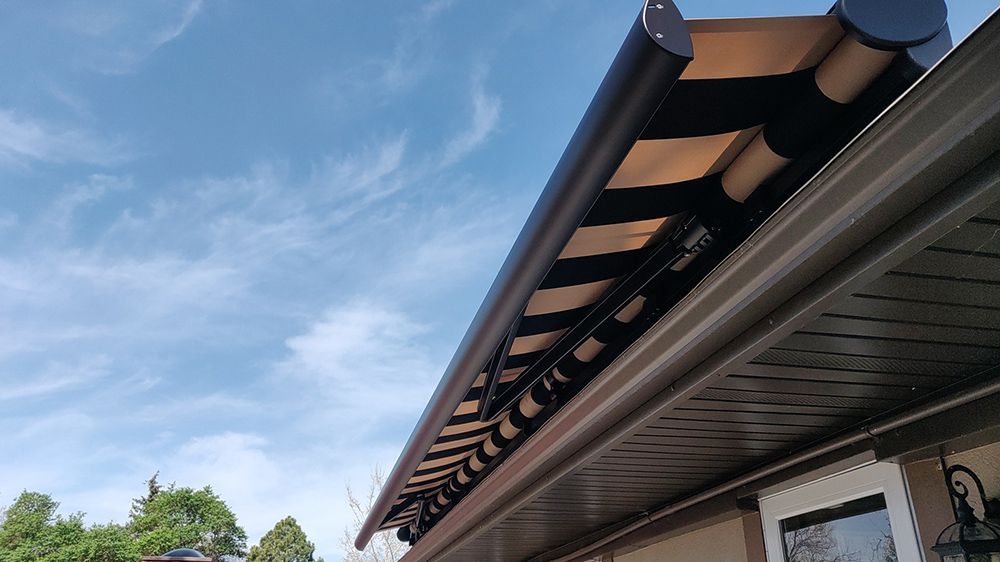 a man is standing under an awning on the roof of a house