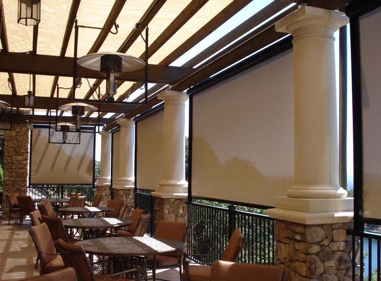 a restaurant with tables and chairs under a pergola