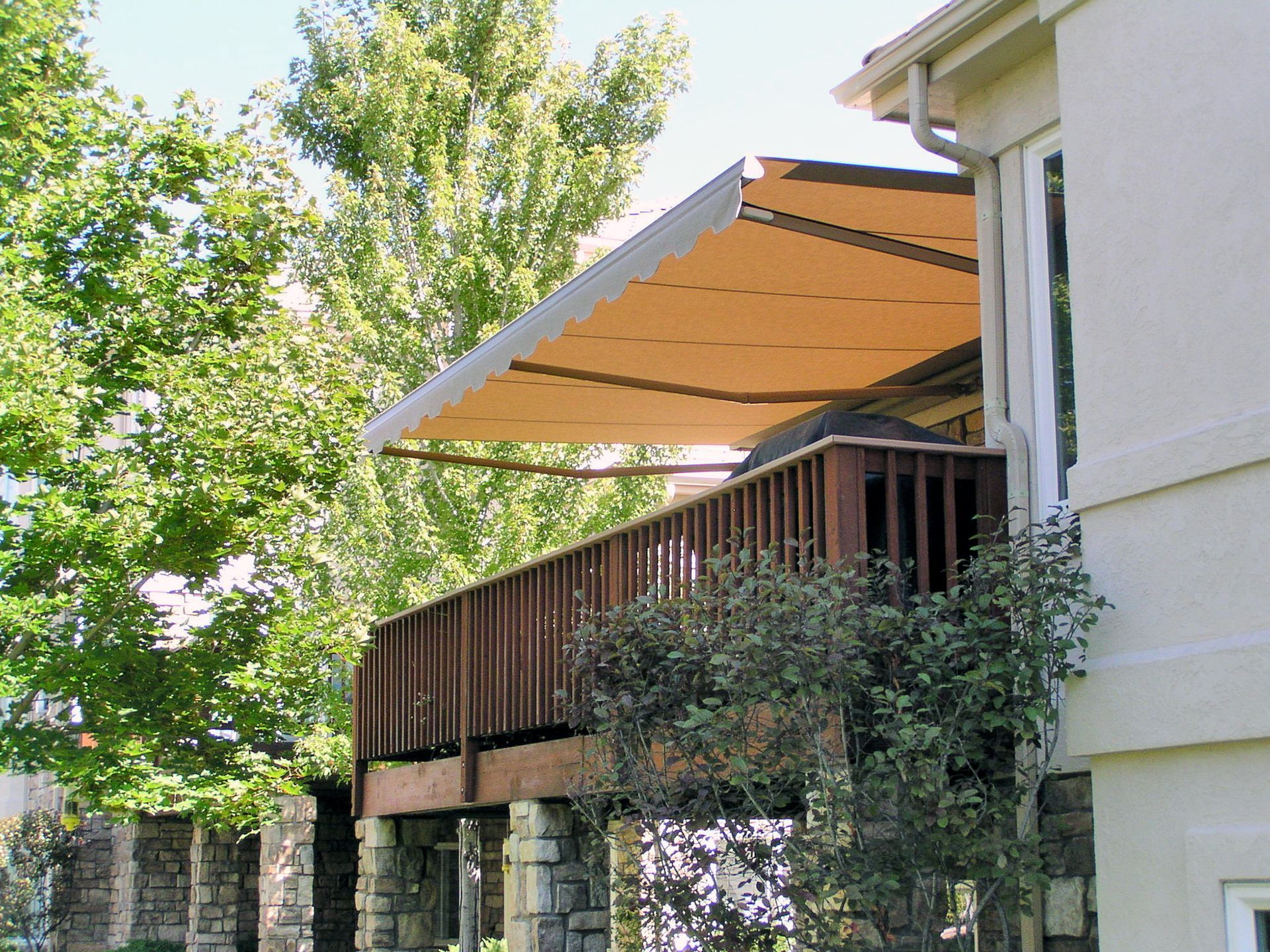 a house with a balcony with an awning over it