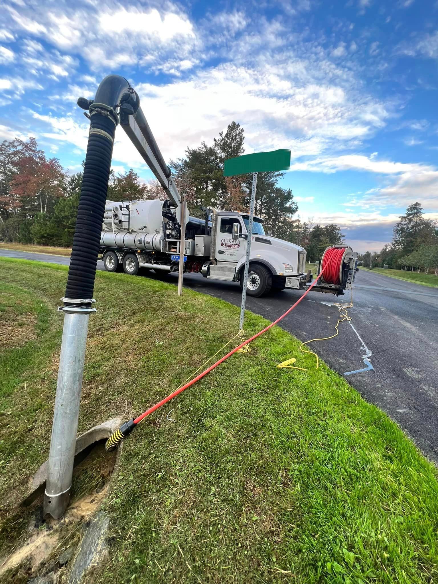 a truck is parked on the side of the road next to a street sign 