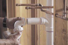 A plumber fixing pipe