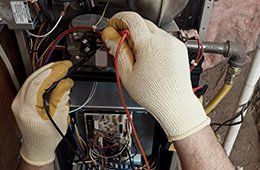 A mechanic repairing heater