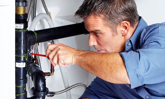 A plumber fixing heater pipe