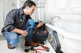 A plumber fixing bathroom pipe