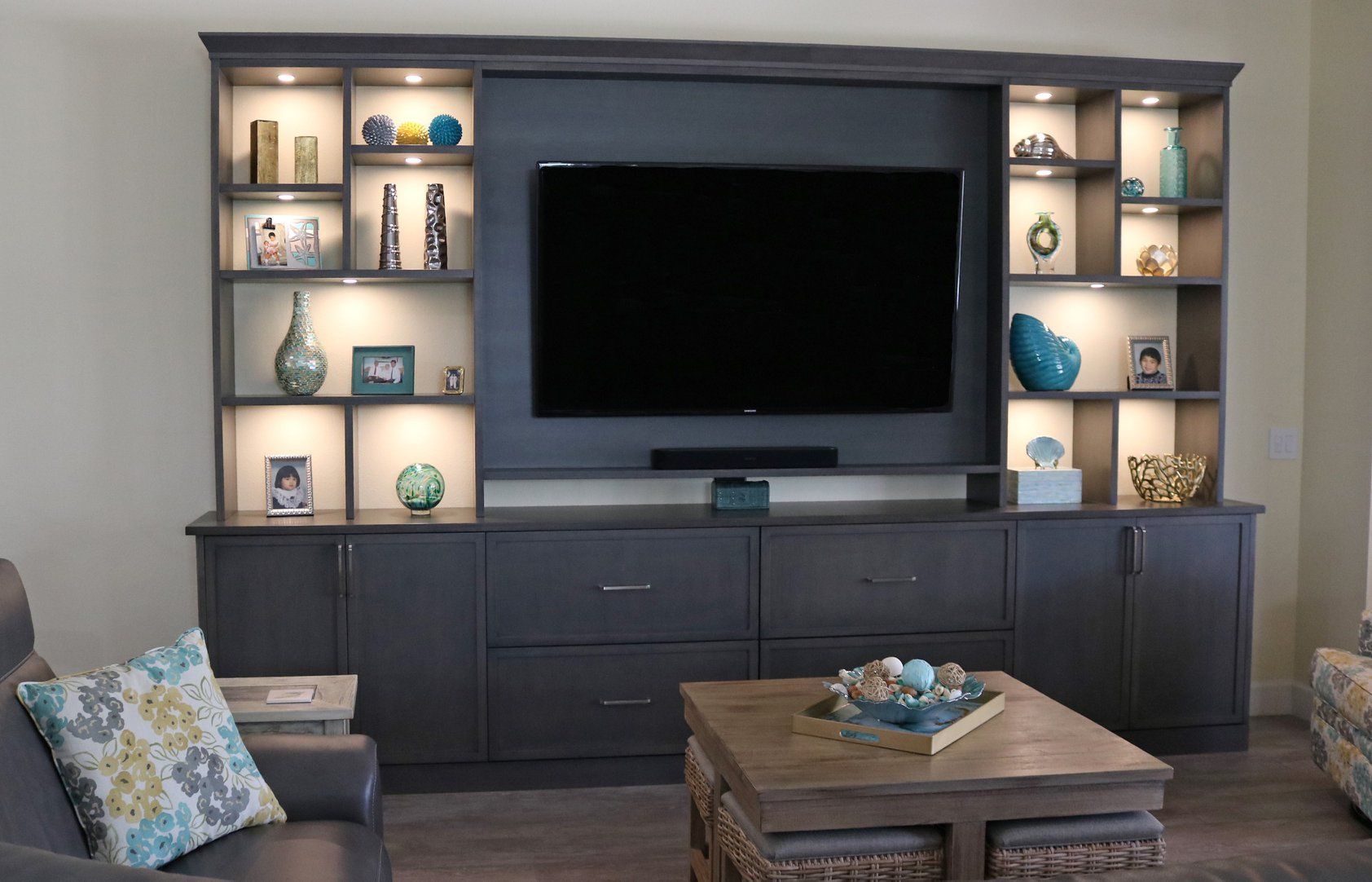 A living room with a large flat screen tv on the wall