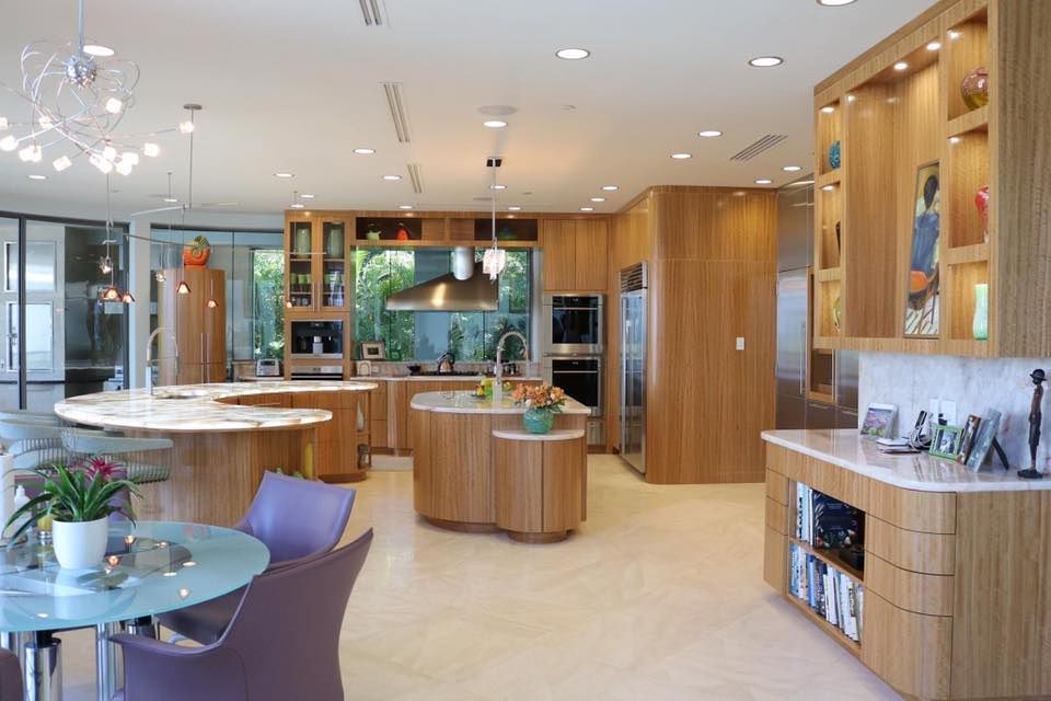A large kitchen with a dining table and chairs in it.