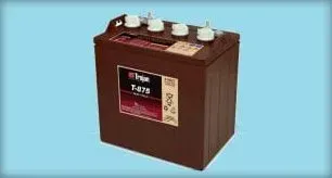 Brown car battery with terminals on top against a light blue background