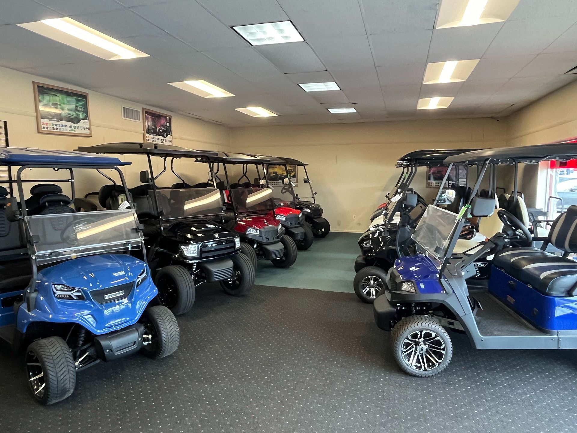 A showroom filled with a variety of golf carts