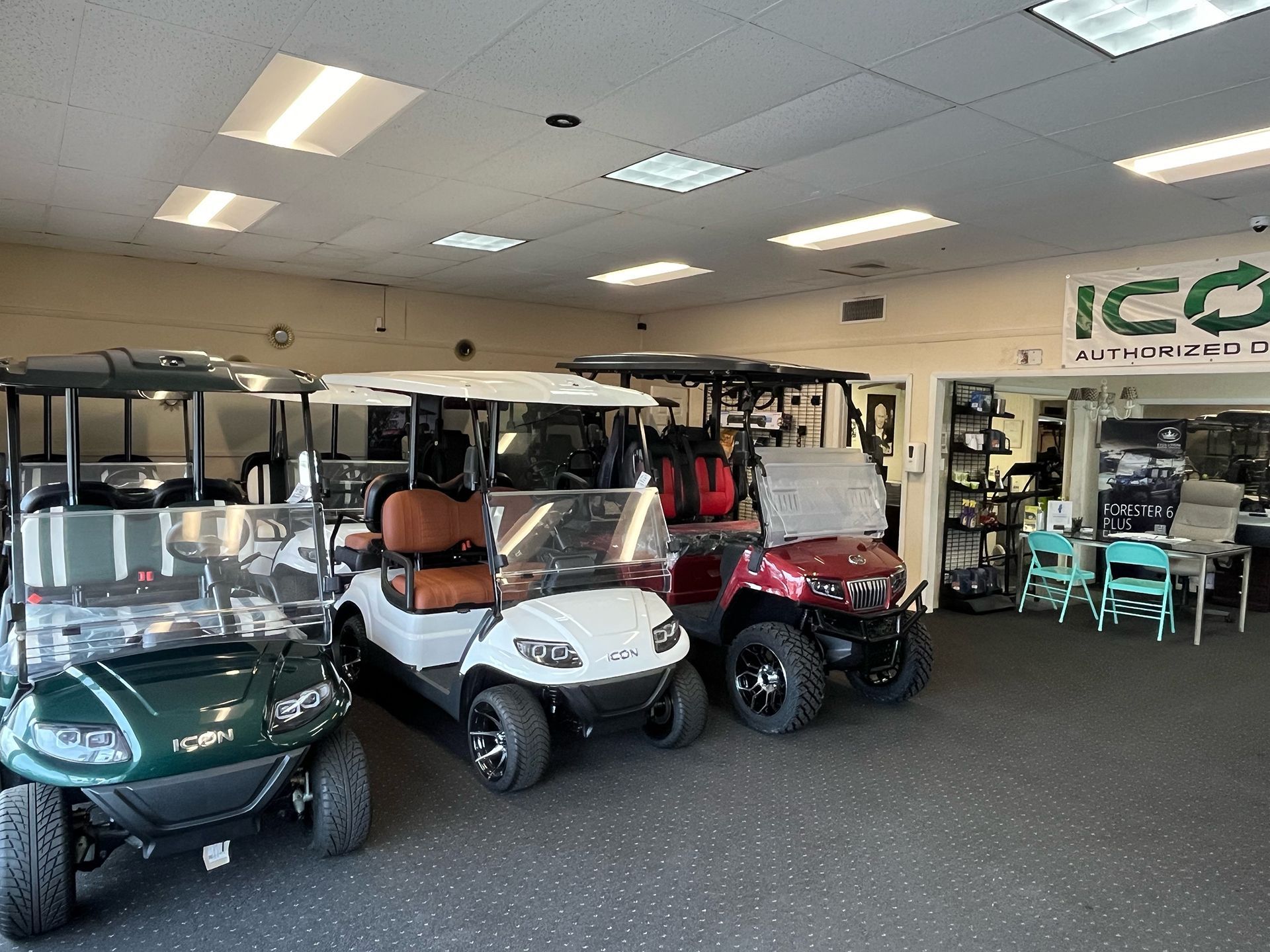 A row of golf carts are lined up in a showroom