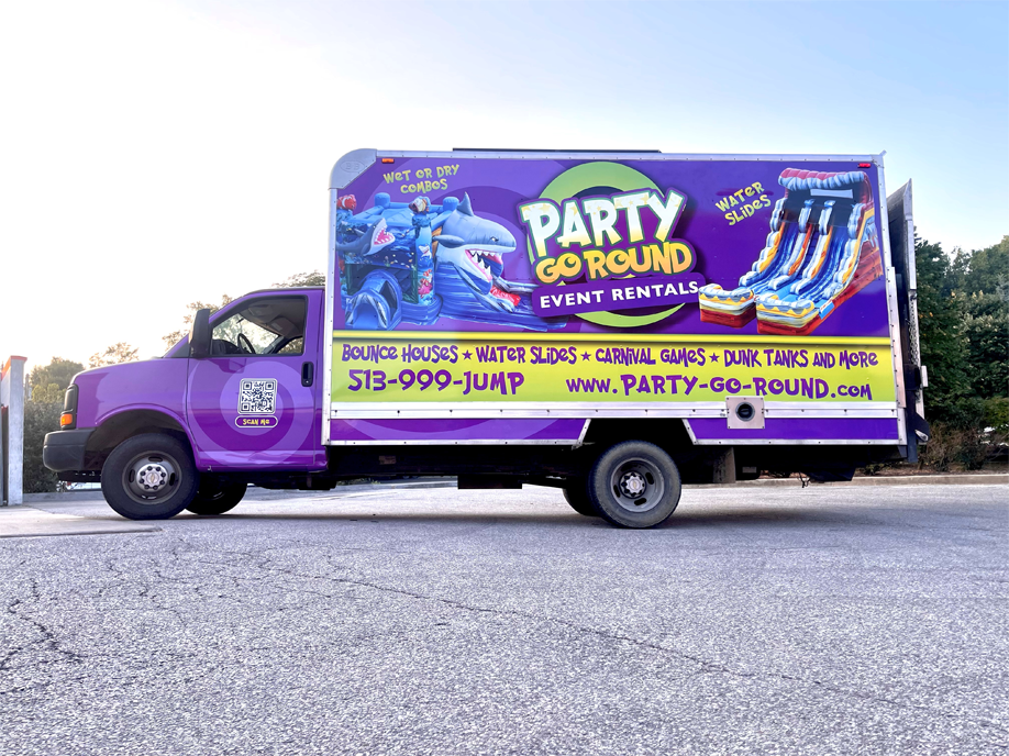A Pink Plumber Mobile van is parked in a snowy parking lot.