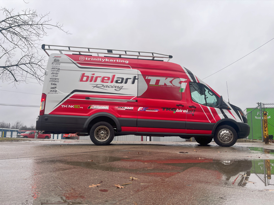 A red birelart van is parked in a parking lot