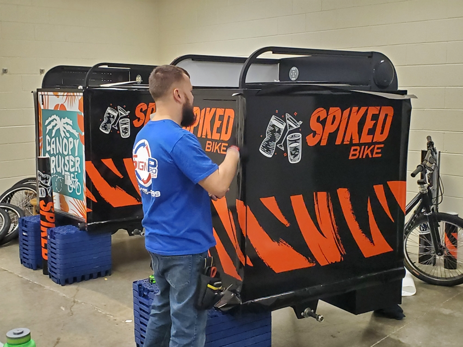 A man is working on a Spiked bike trailer.
