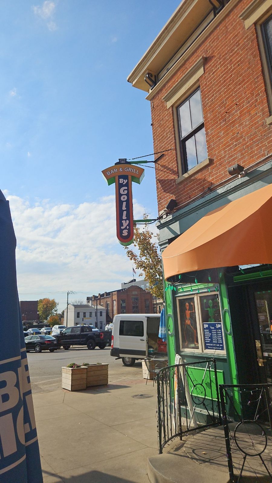 A brick building with a sign that says bar & grill by golly'son it