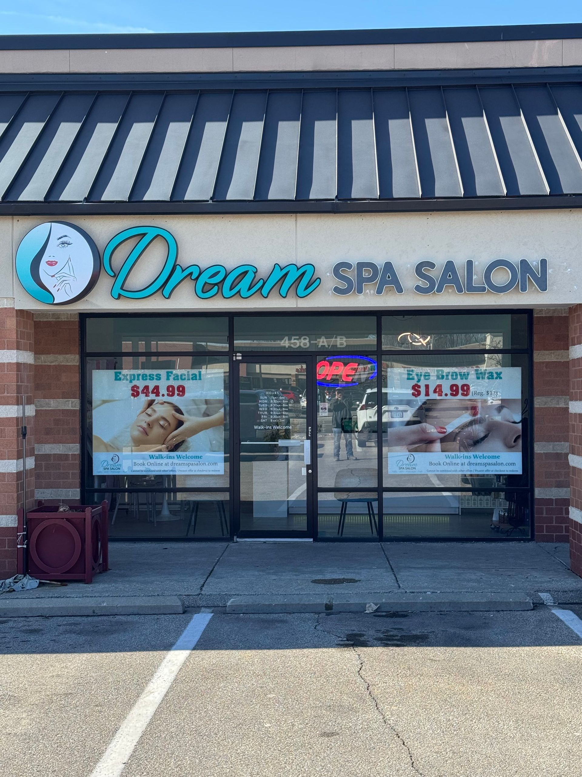 The front of a dream spa salon with a parking lot in front of it.