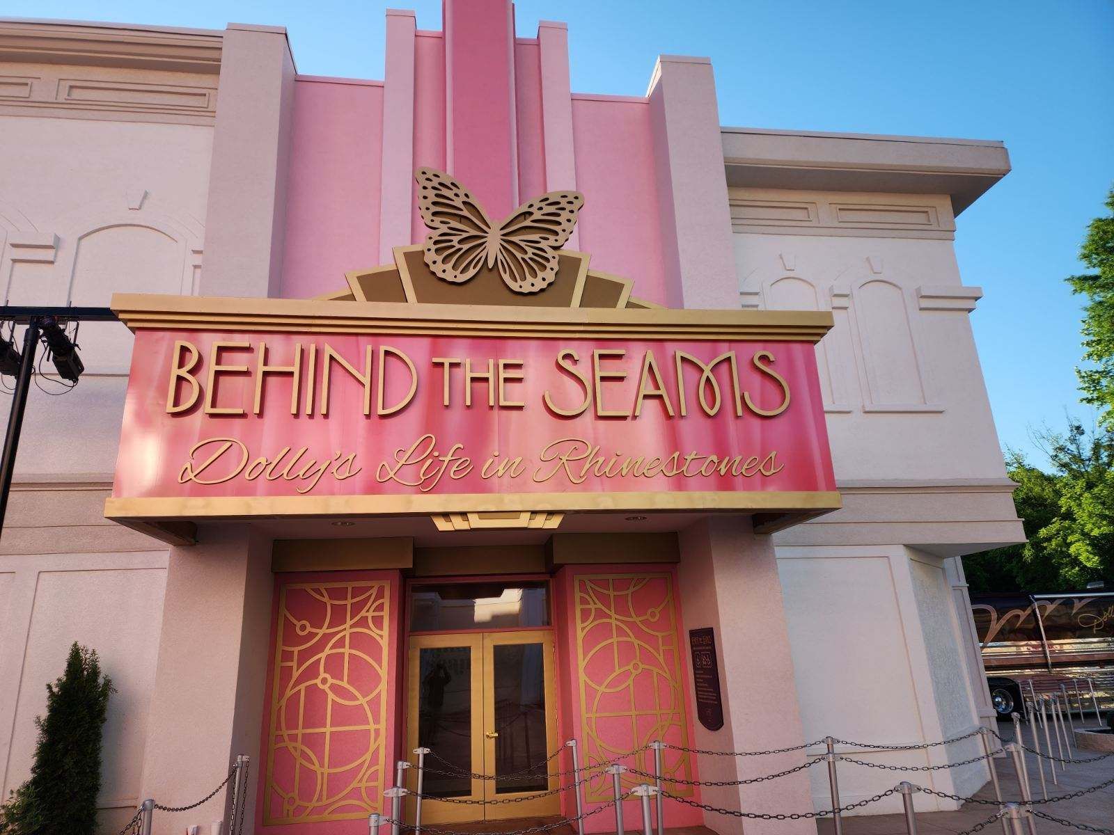 A pink building with a sign that says behind the seams