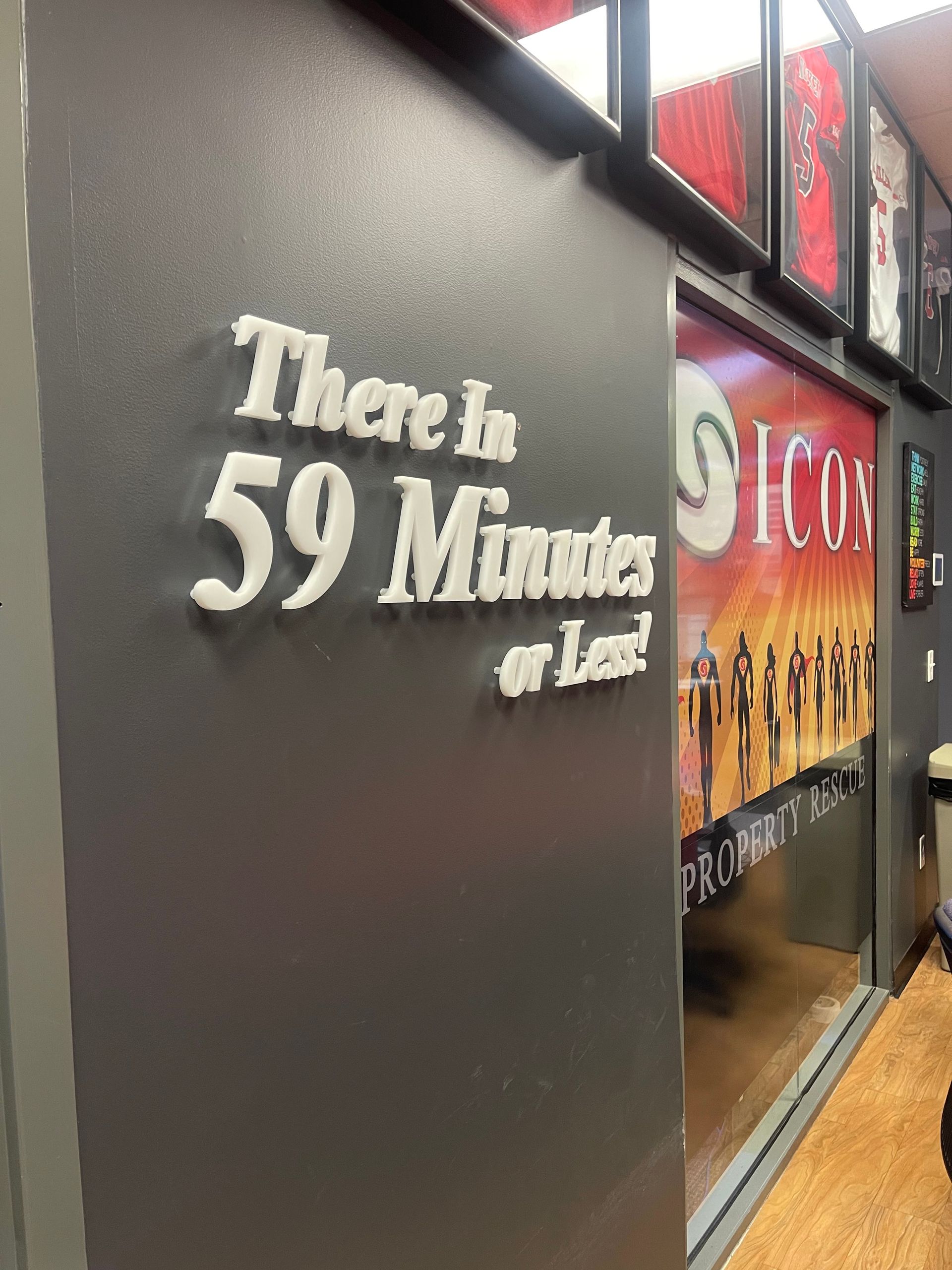 A sign on a wall that says there in 59 minutes or less