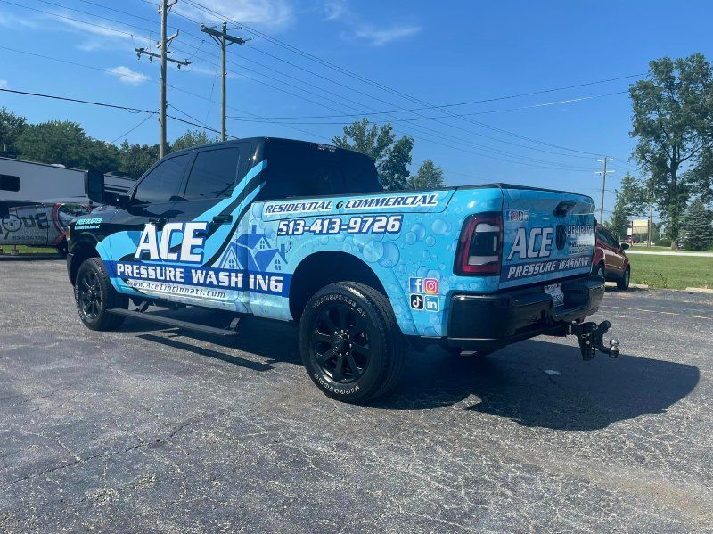 A blue and black truck is parked in a parking lot.