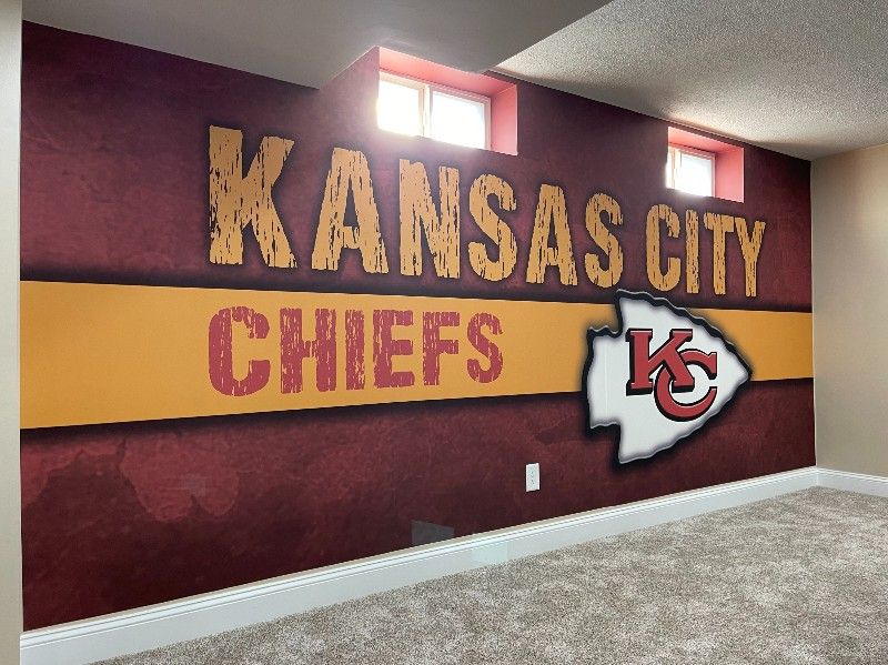 A wall with a kansas city chiefs logo on it