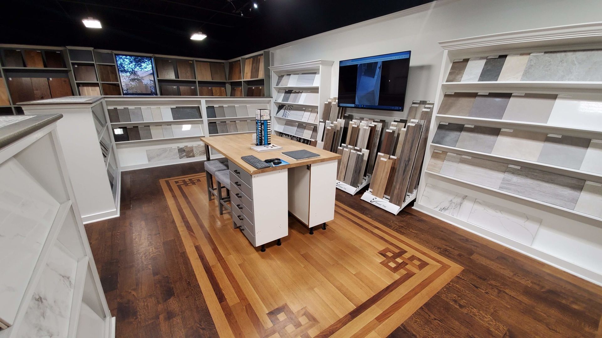 Interior of a flooring showroom with wood and tile samples on display.