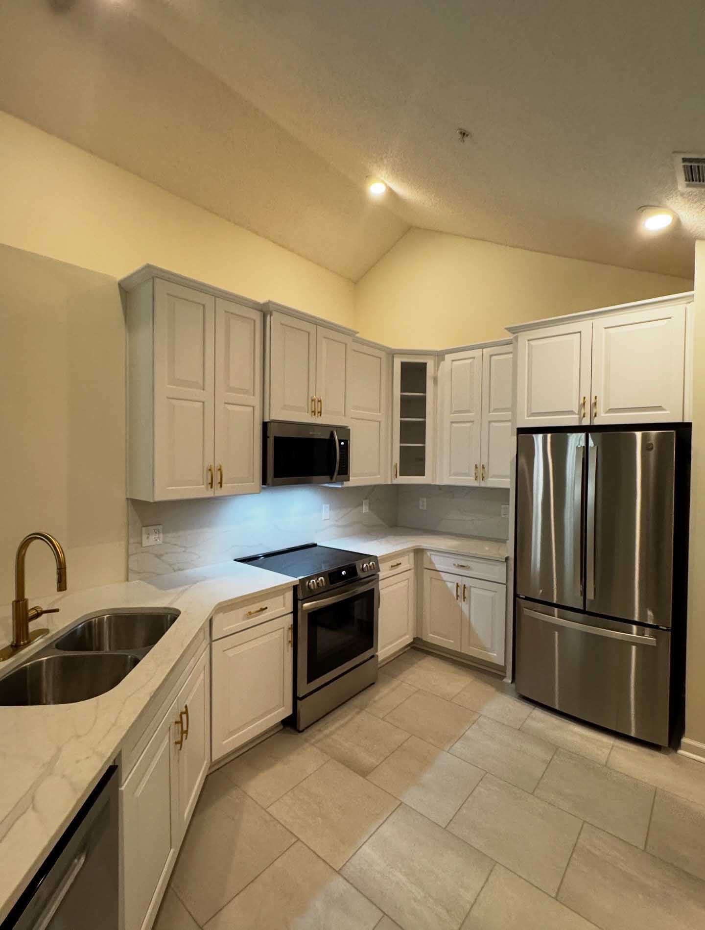 Marble-tiled bathroom with curved built-in bench. Gray and white tones. Shower area.