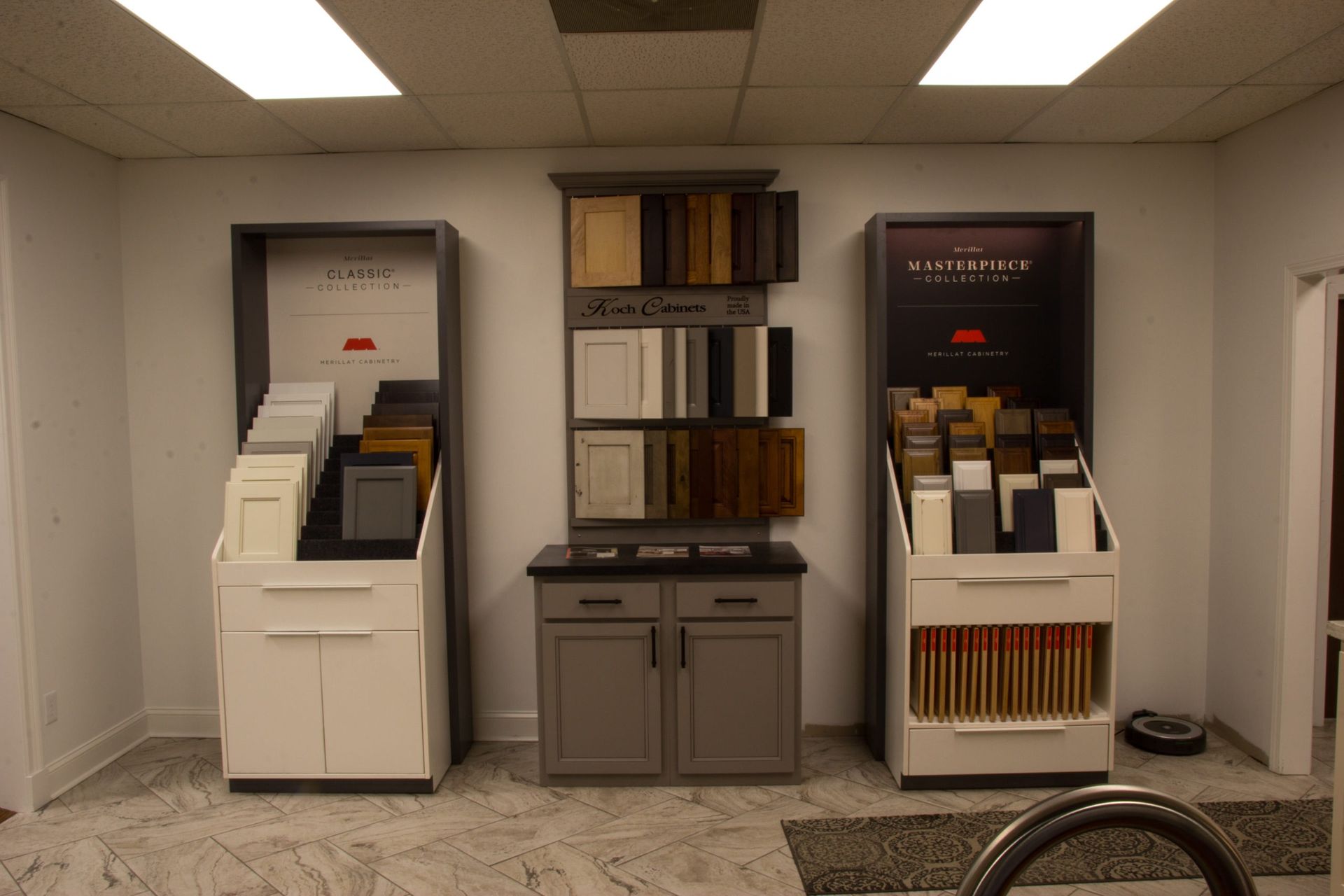 Kitchen cabinet samples displayed in a showroom with various colors and styles.