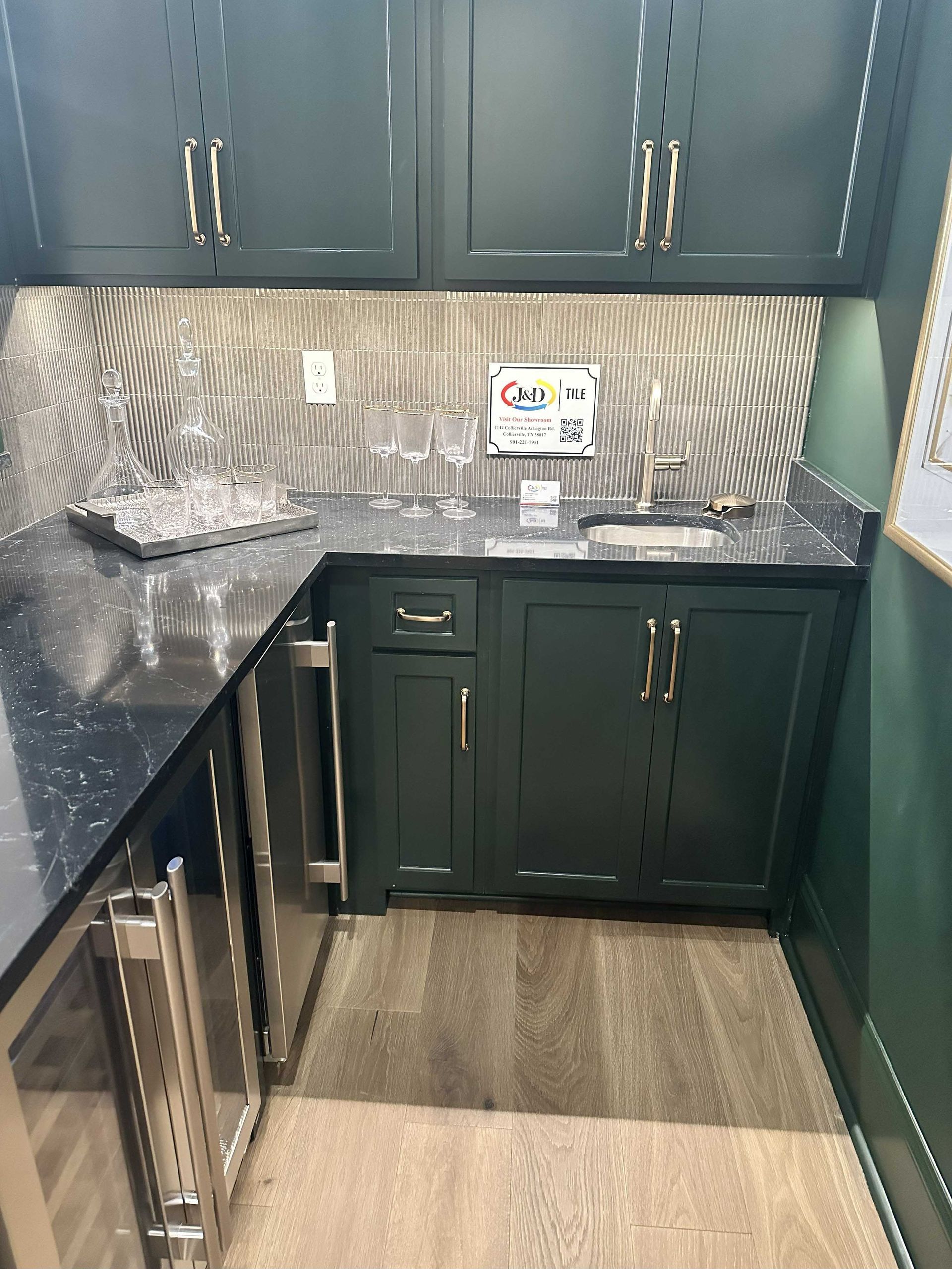 Entryway with gray and black patterned tile floor, wooden door, and view into another room with a piano.