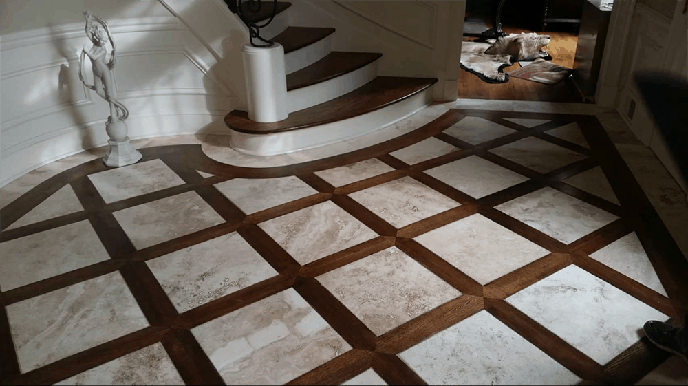 Entryway with a checkered wood and marble floor, stairs, and a white sculpture.