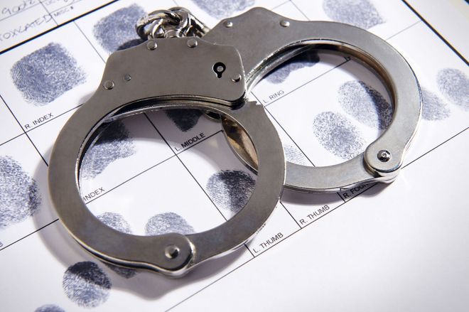 Handcuffs on a fingerprint identification card.