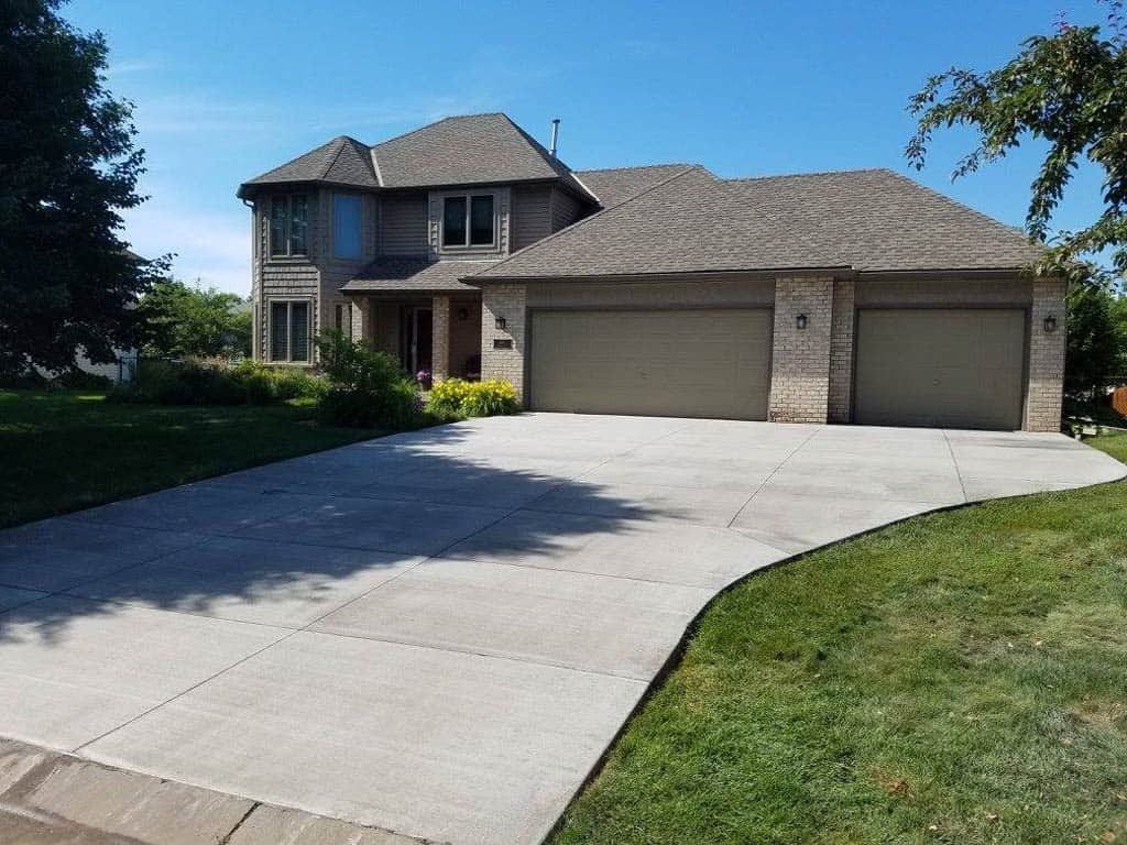 Two-story brick house with a driveway and two-car garage.