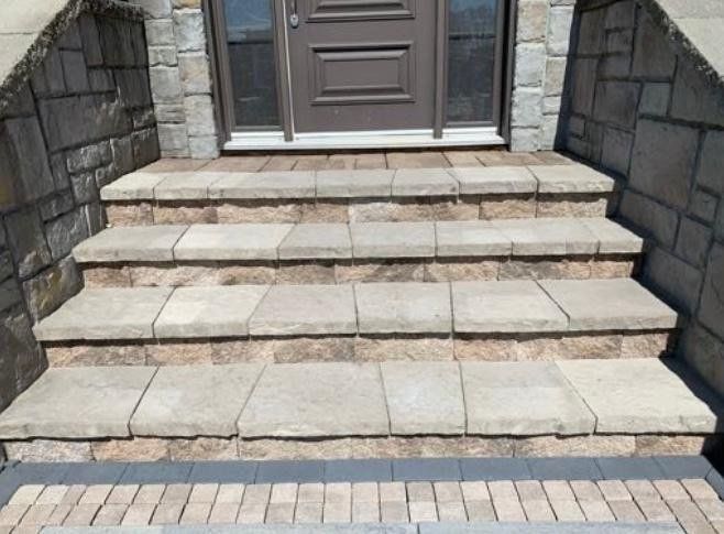 A set of stairs leading up to a doorway of a house.