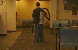 Man cleaning the carpet of the waiting area