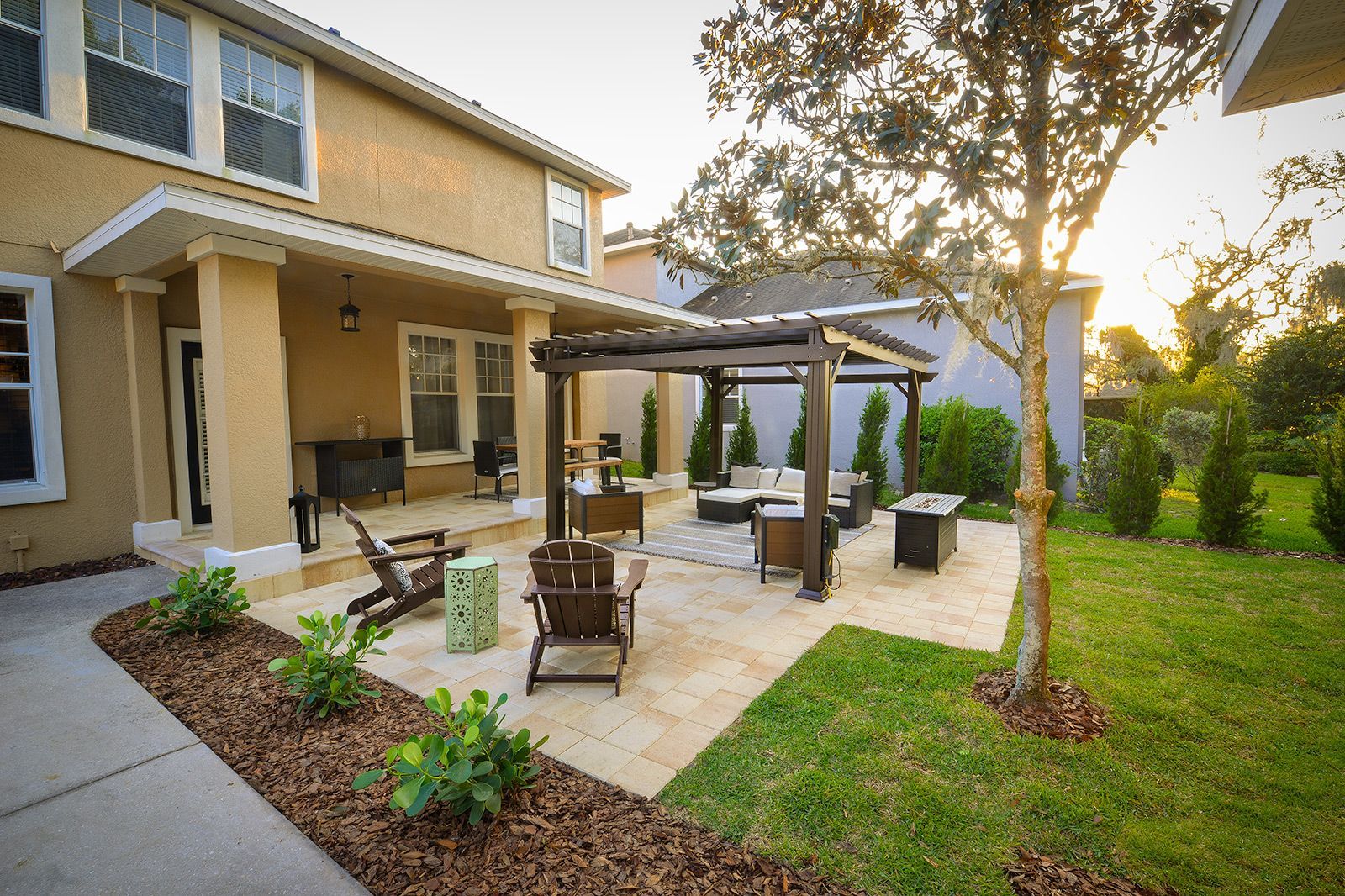 A house with a patio and a pergola in front of it