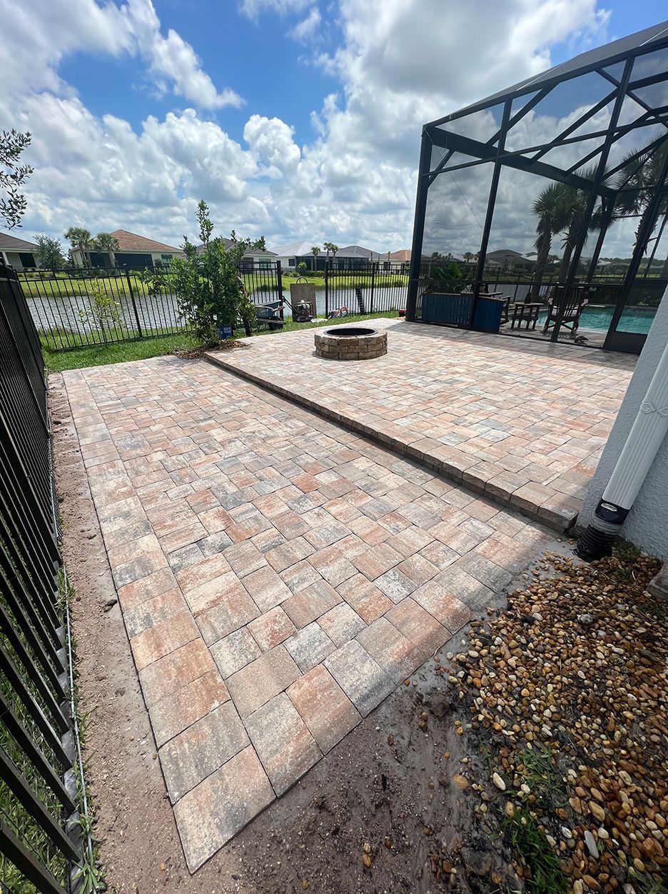There is a fire pit in the middle of the patio.
