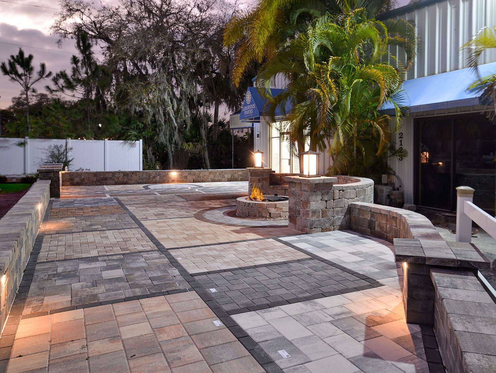 A patio with a fire pit in the middle of it