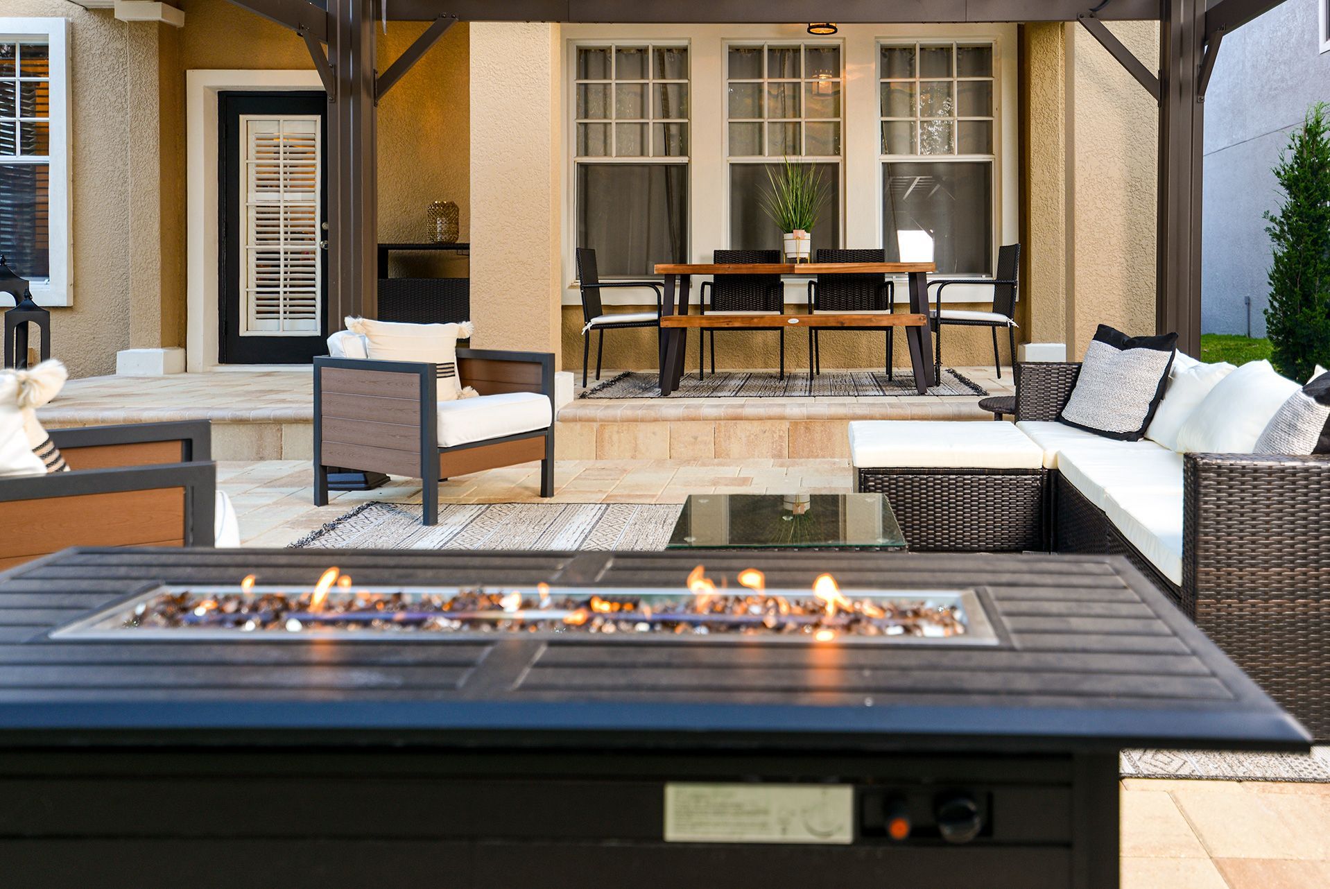 There is a fire pit in the middle of the patio.