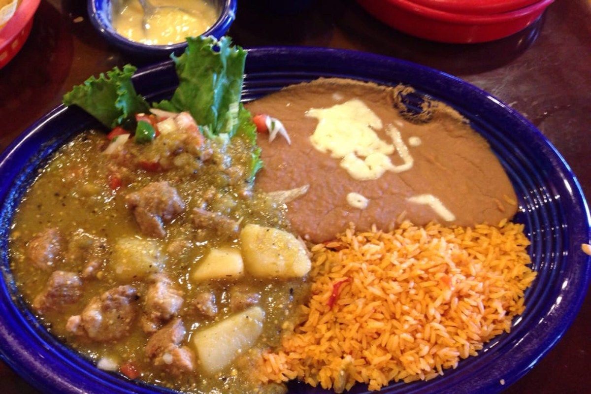 A plate of food with rice and beans on a table.