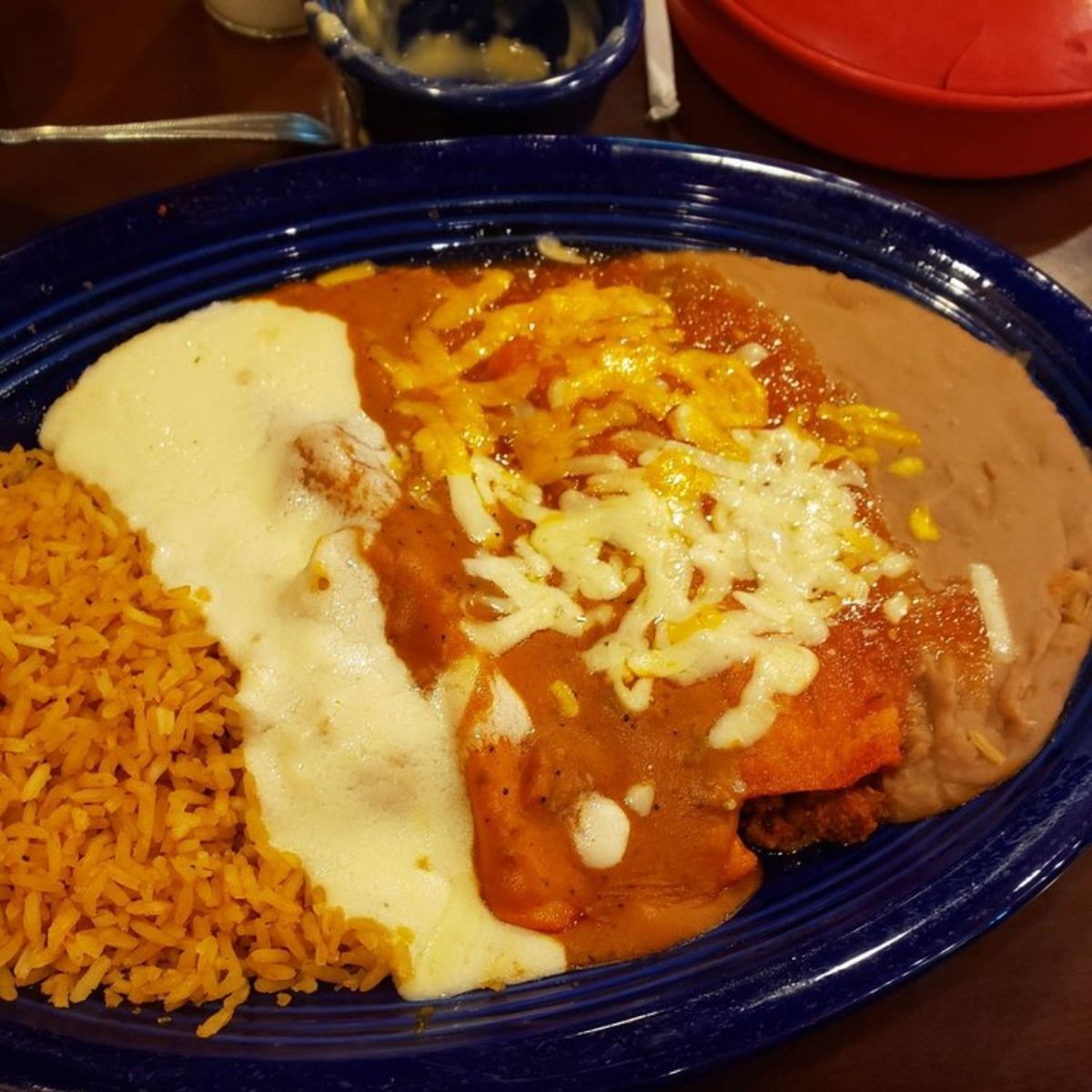 A plate of food with rice and beans on a table