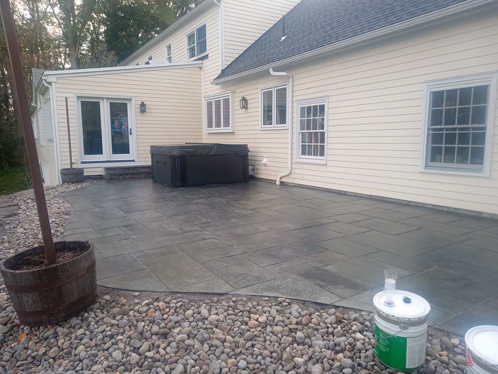 A large white house with a patio in front of it.