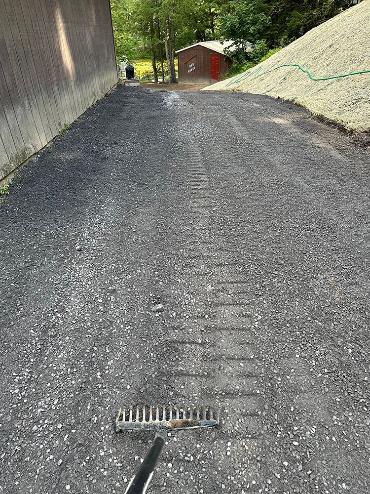 A rake is sitting on the side of a road.