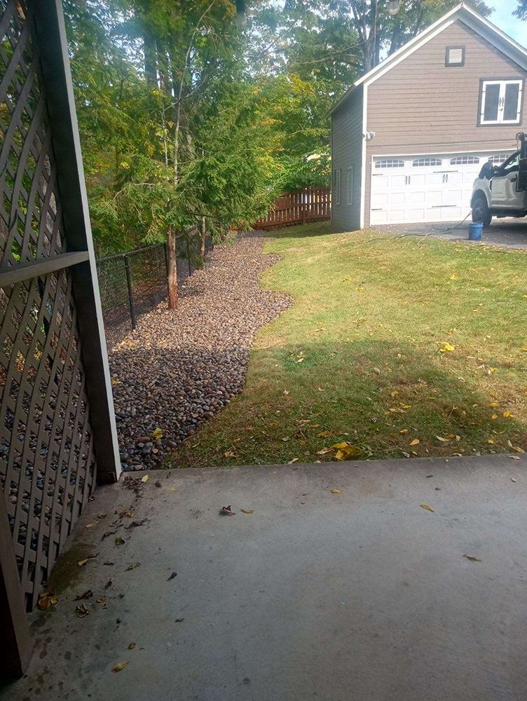 A car is parked in a driveway next to a house.