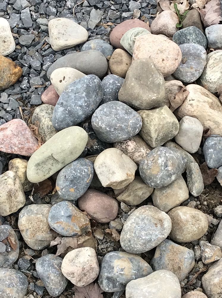 A pile of rocks sitting on top of a pile of gravel.