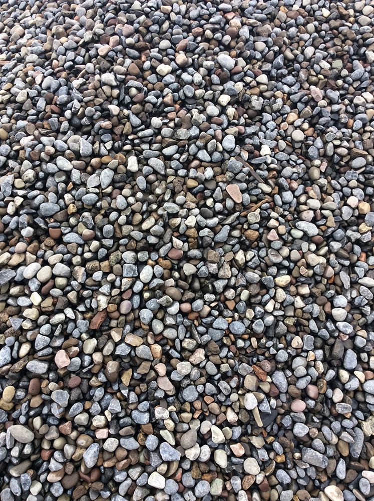 A pile of rocks is sitting on the ground.