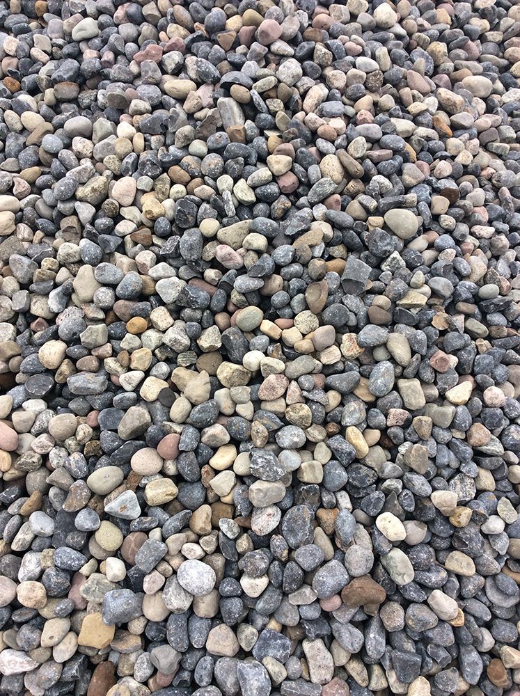 A pile of rocks is sitting on the ground.