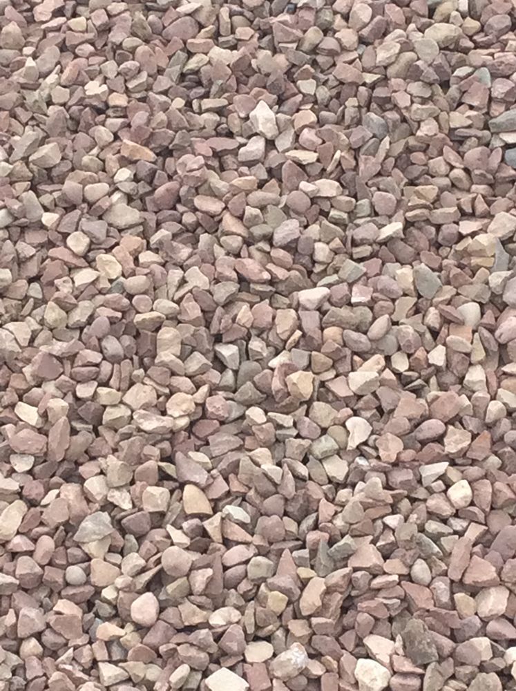 A pile of gravel is sitting on the ground.