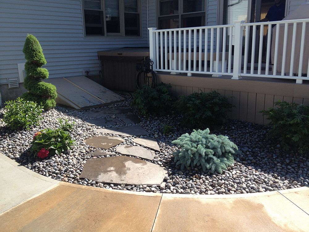 A walkway leading to a deck with a white railing