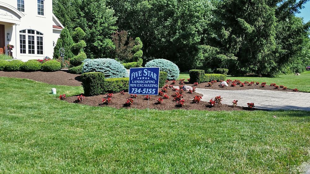 A house with a sign in front of it that says for sale